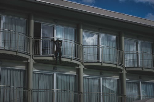 Black clothes on railing of balcony