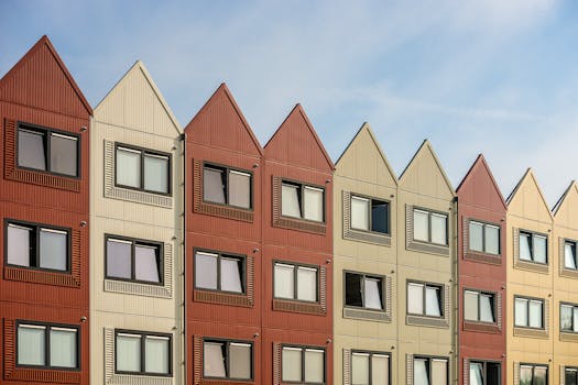 A vibrant row of gable-roofed residential buildings with metal facades.