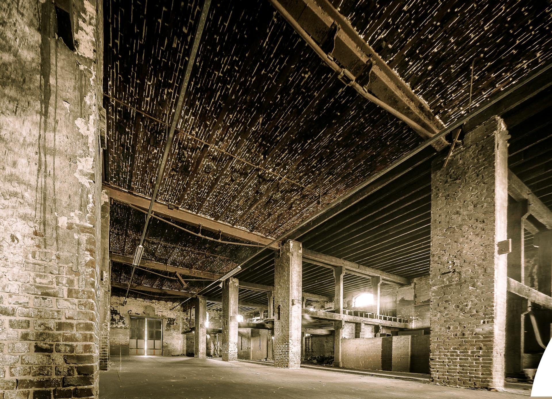 Explore a vintage warehouse interior with exposed brick walls and a rustic atmosphere.