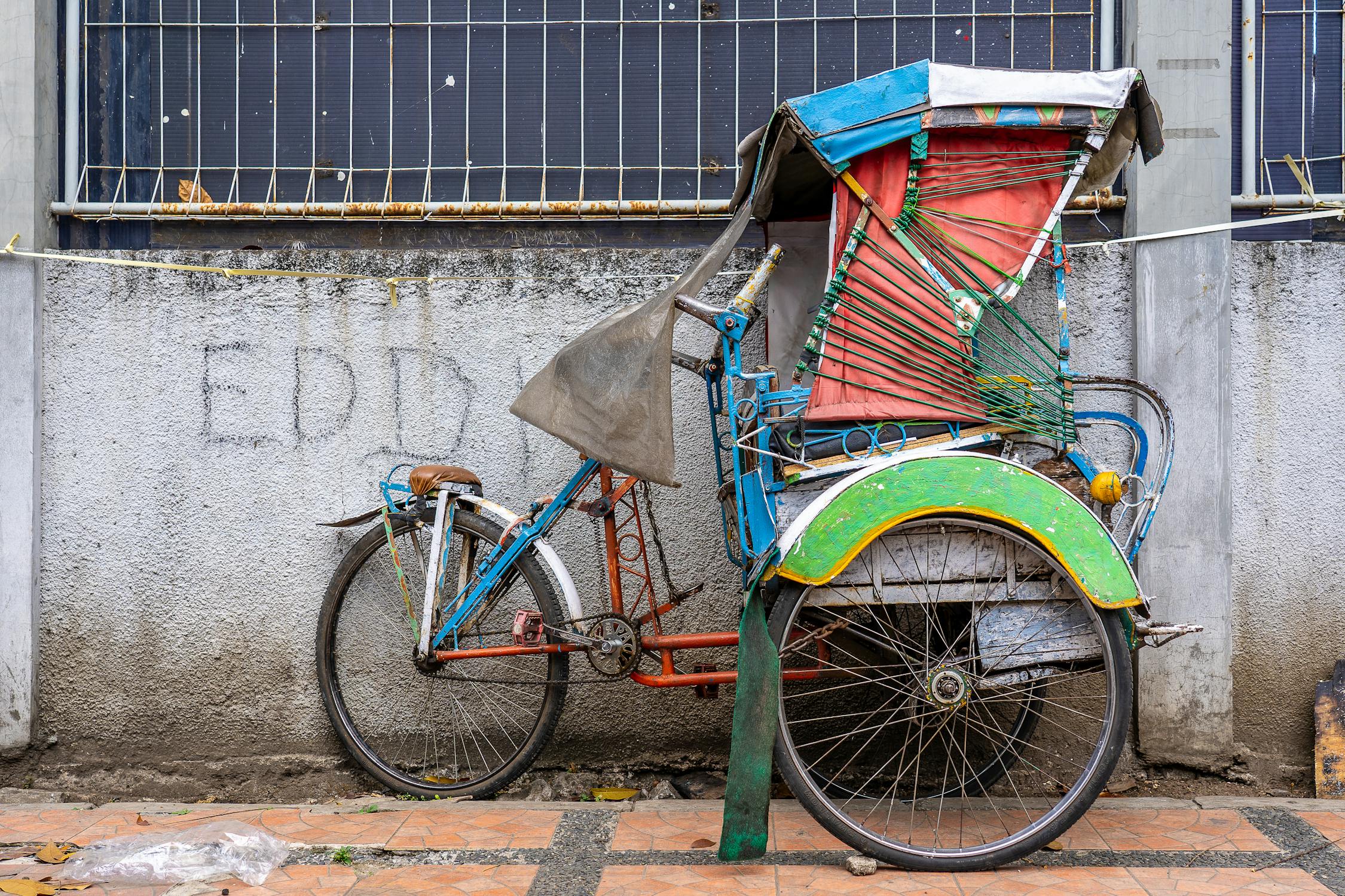 Colorful Rickshaw Parked by Wall · Free Stock Photo