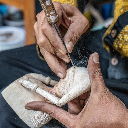 Free Elderly Person Carving a Figurine in Wood  Stock Photo