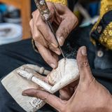 Hands carving a relief block with a gouge, by Mike van Schoonderwalt on Pexels