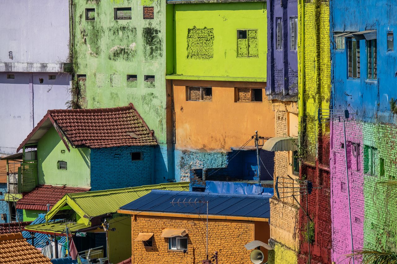 brightly colored urban houses with vibrant painted facades create a li