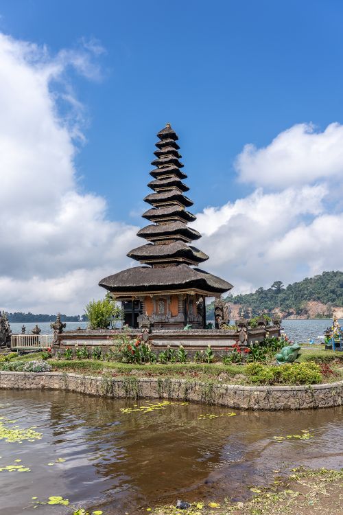 Free A traditional Balinese pagoda at Ulun Danu Beratan Temple on Lake Bratan in Bali, Indonesia, under clear blue skies. Stock Photo
