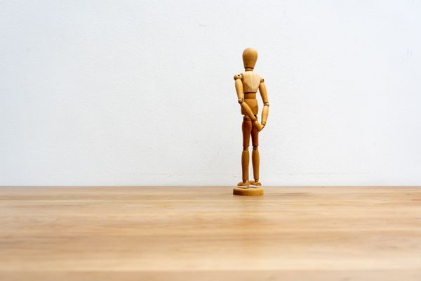 A jointed wooden artist figure standing on a floor — photo by Mike van Schoonderwalt on Pexels