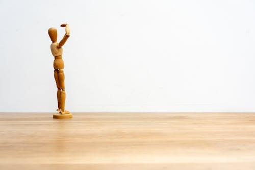 Free Wooden Figurine against a White Background Stock Photo