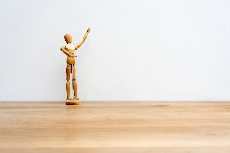 Wooden Figurine With Raised Arm