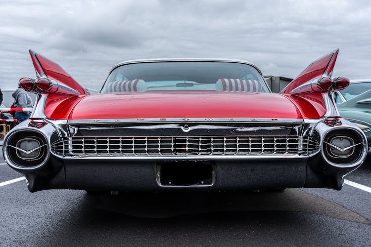 Back View Of A Red Cadillac Fleetwood Classic Car