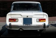 White Car With Blue and White License Plate