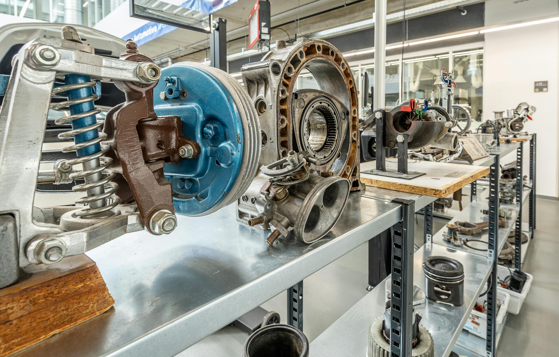 Showcase of metal engine components in an industrial workshop setting.