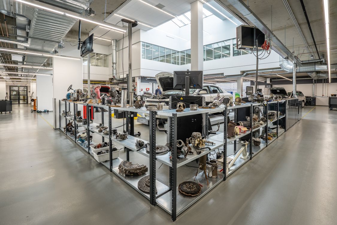 Automotive engine parts arranged on workshop storage shelves reference image