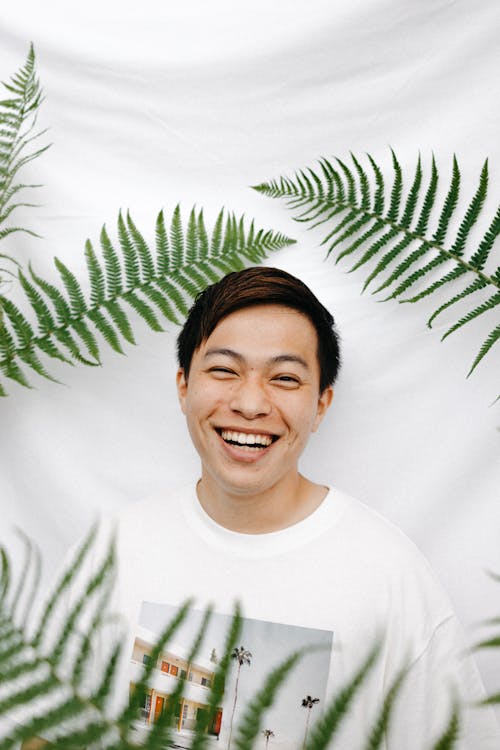 Happy Man near Green Leaves