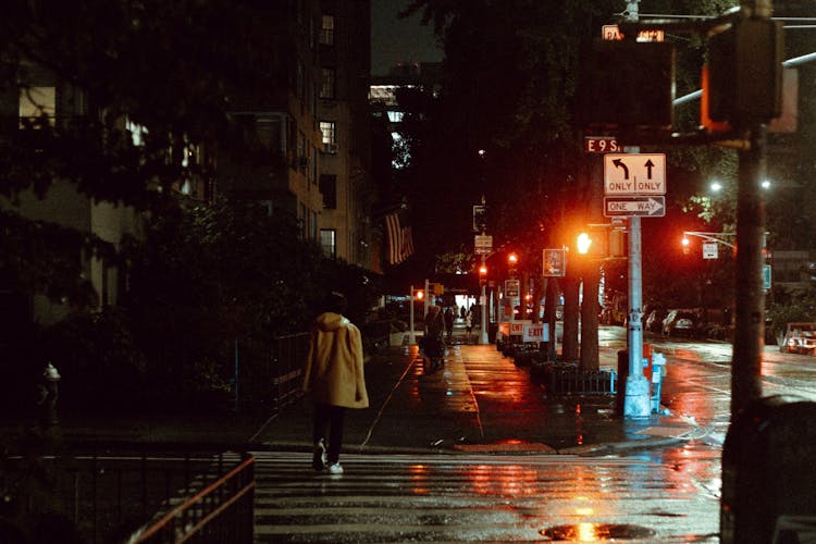 Anonymous Woman Crossing City Road At Night