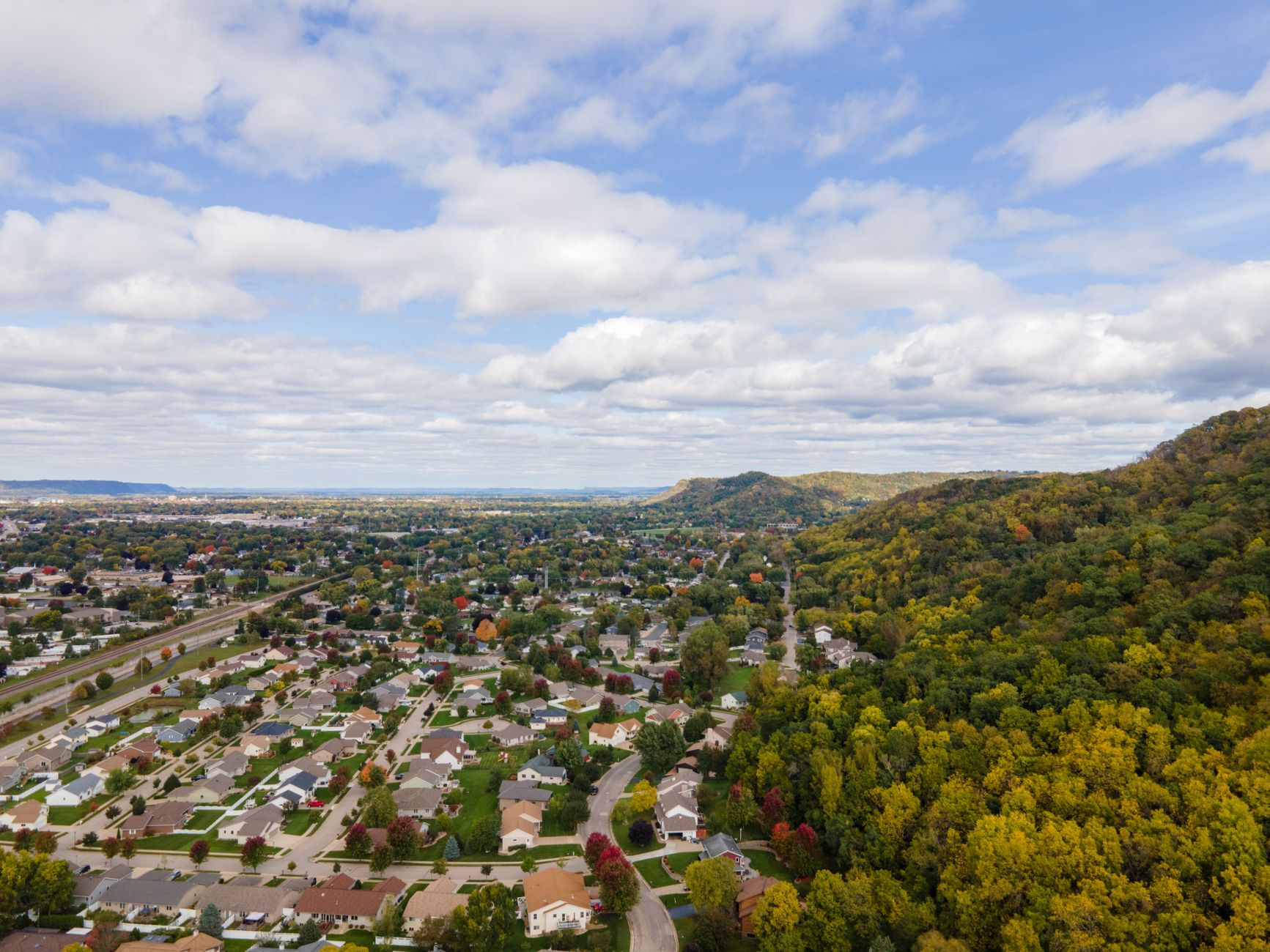 A stunning aerial view of residential neighborhoods beside lush forests in La Crosse, Wisconsin.