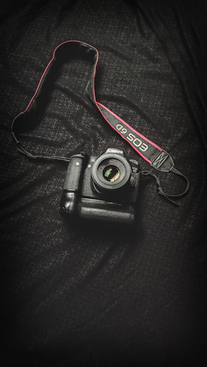 Free Black Canon Dslr Camera on Black Textile Stock Photo