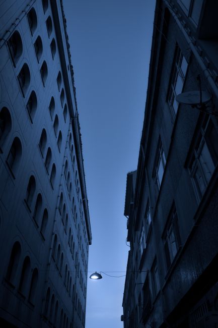 Low angle view of tall buildings and street lamp in Istanbul. Dramatic urban scene.