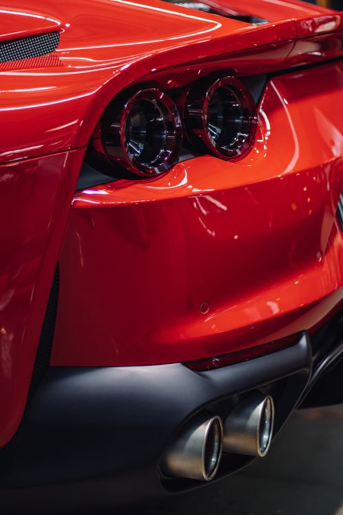 Free Close-up of a stunning red sports car rear with sleek design and carbon fiber elements. Stock Photo