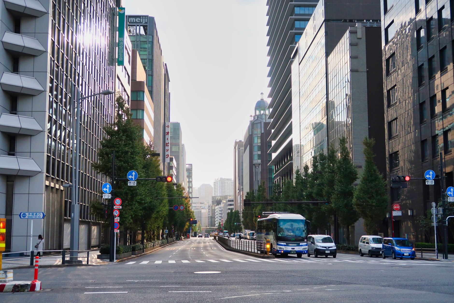 A lively city street lined with high-rise buildings reflecting urban dynamism and modern architecture.