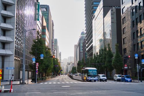 Free A lively city street lined with high-rise buildings reflecting urban dynamism and modern architecture. Stock Photo