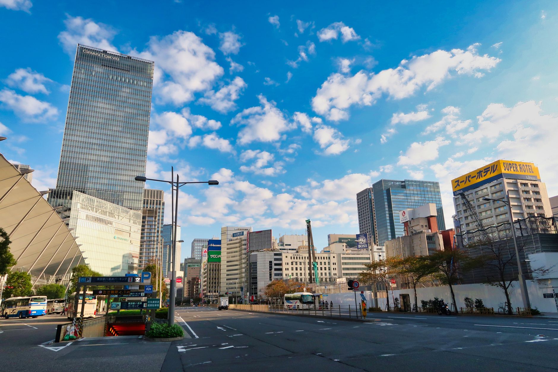 Stunning view of Tokyo's modern skyline with skyscrapers under a vibrant blue sky.