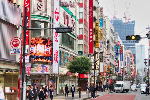 Free Bustling city street in Shinjuku, Tokyo with neon signs and people. Stock Photo