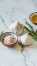 Garlic Beside Green Leaves on White Table