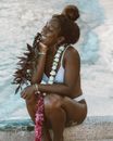 Woman in White Tank Top Sitting on Beach