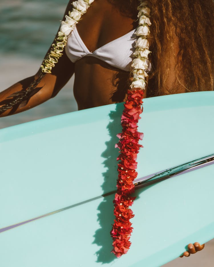 A Woman In White Bikini Top Wearing A Red And White Lei