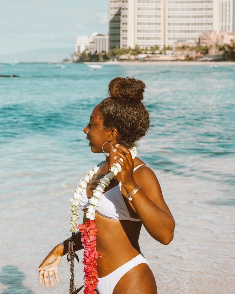 Woman Wearing Bikini And Lei On Beach