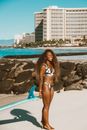 African American Girl in Bikini Getting Sunbathe on Beach in Coastal Resort