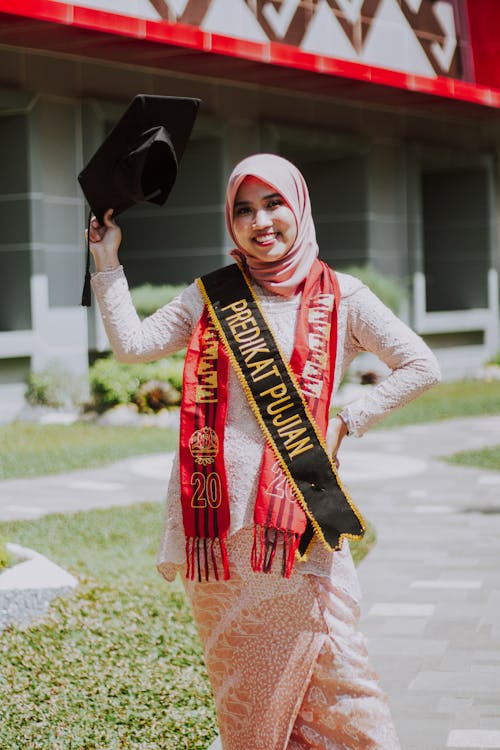 A Woman Holding Her Graduation Hat