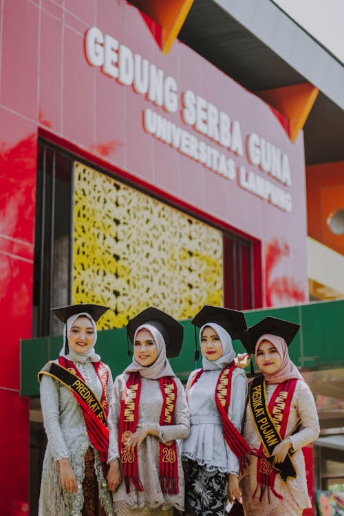 2 Women Wearing Academic Dress Smiling