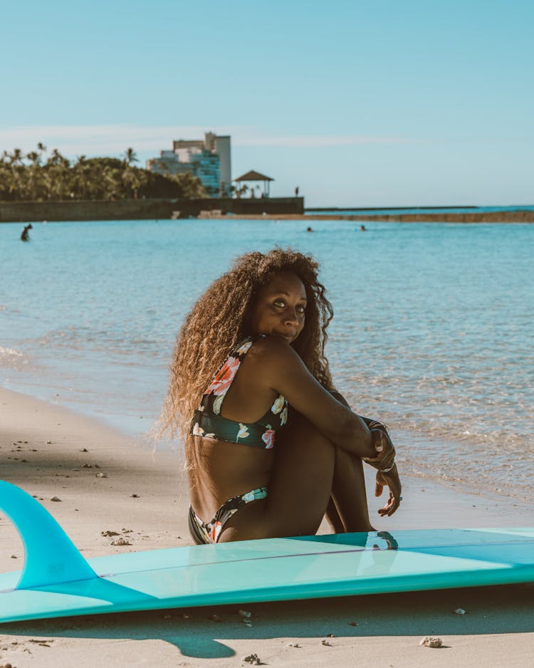 Surfer Sitting On Beach