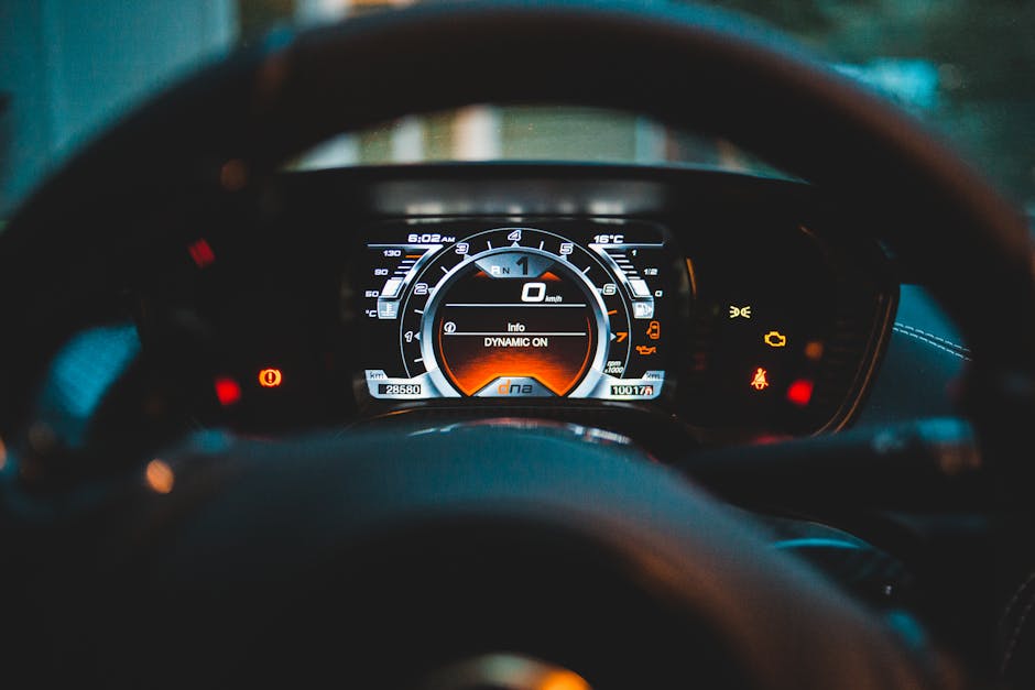 Modern instrument panel with colorful symbols on display near steering wheel in car