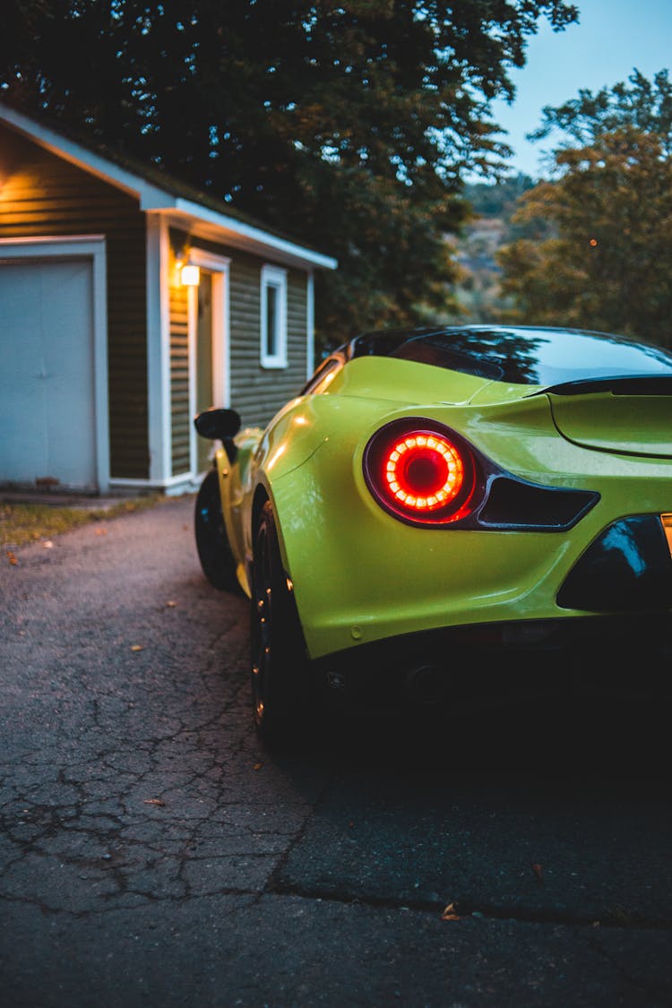 Luxury Sports Car On Road Near House In Evening