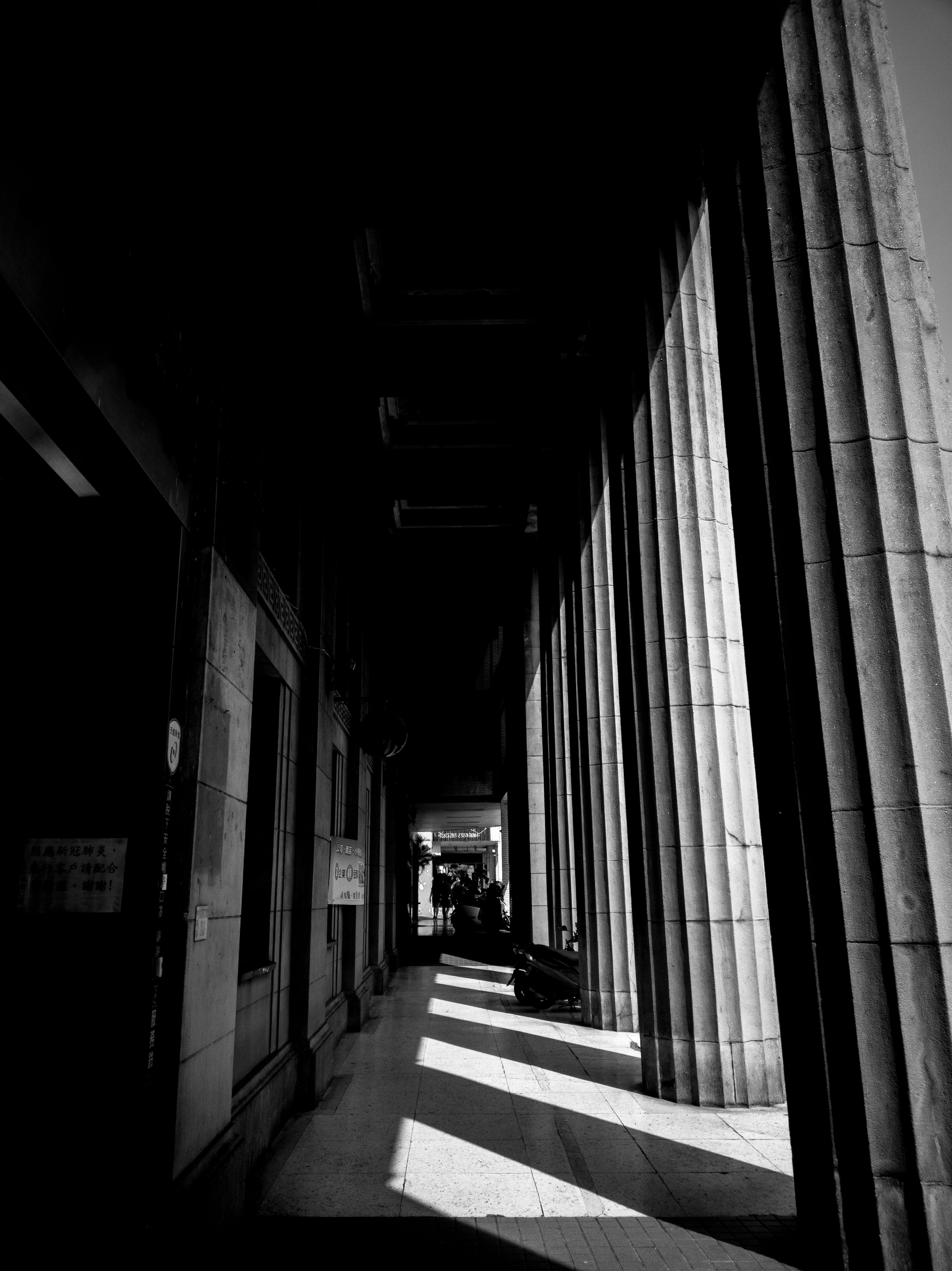 Free Captivating grayscale image of tall columns casting shadows in Tainan City, Taiwan. Stock Photo