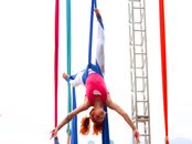 Woman in Pink Tank Top and White Leggings Tied on Blue Textile