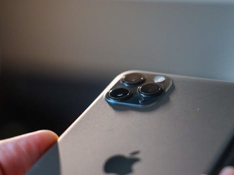 Detailed view of a modern smartphone's triple camera setup in focus.