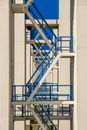 Blue Metal Staircase Outside White Concrete Wall