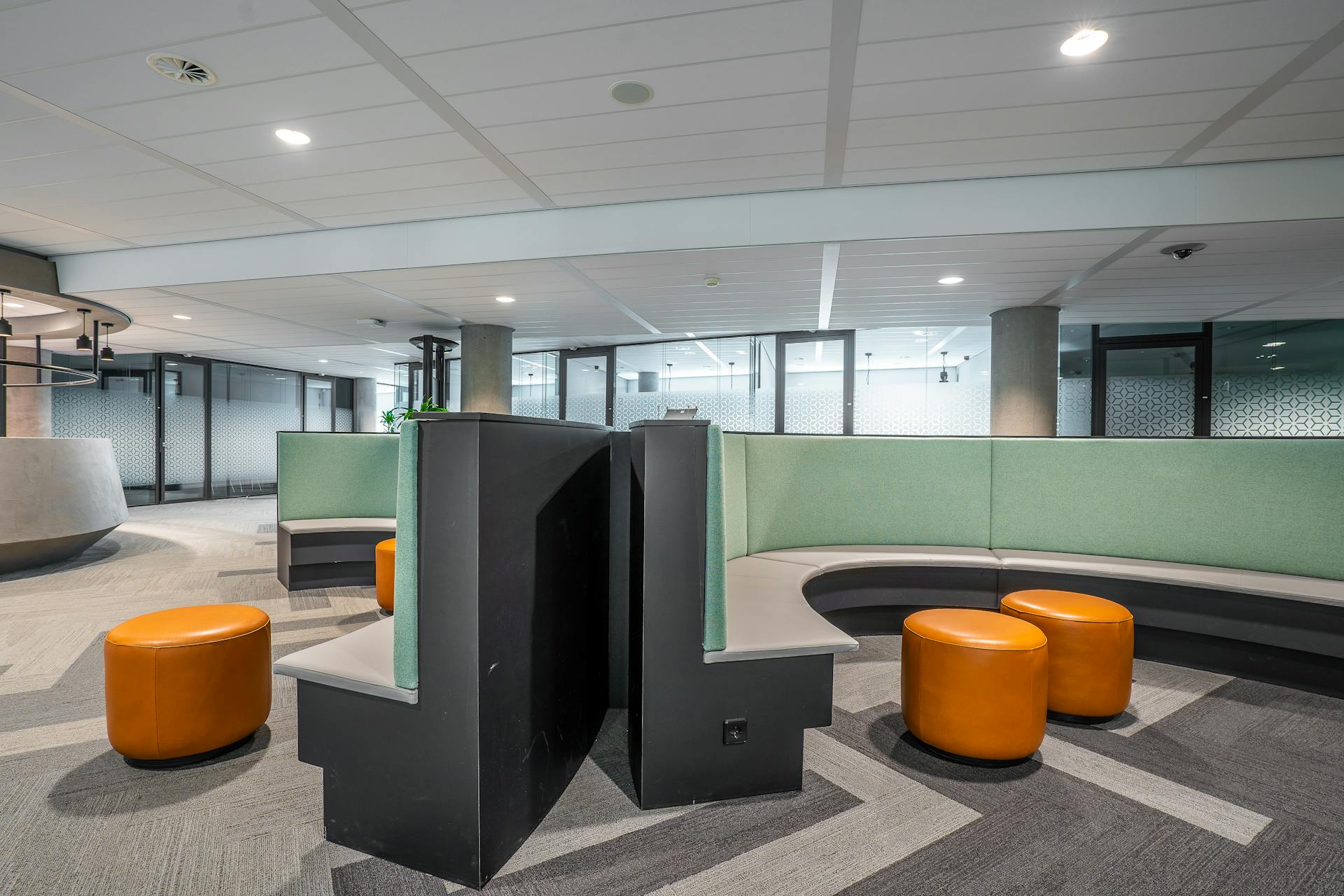 Contemporary office lobby featuring unique seating design and vibrant decor for a welcoming workspace.