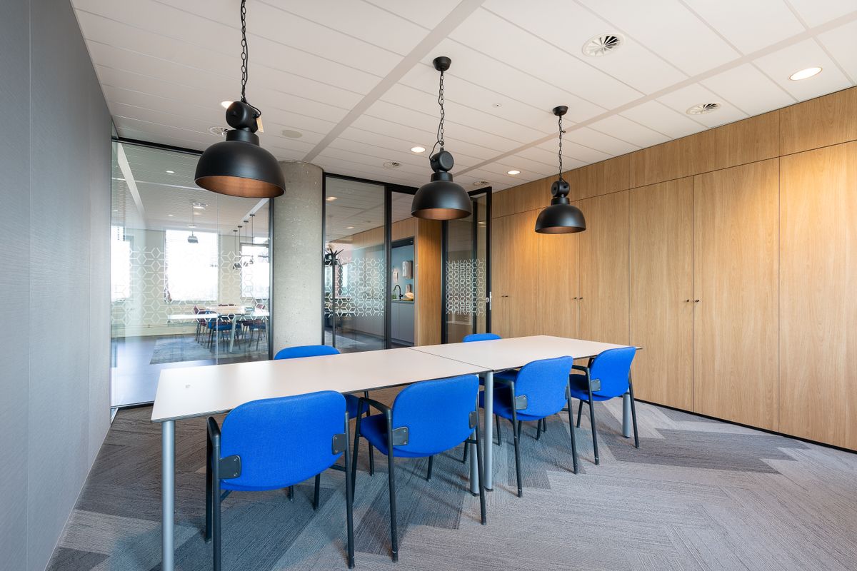 Real modern office meeting room with blue chairs