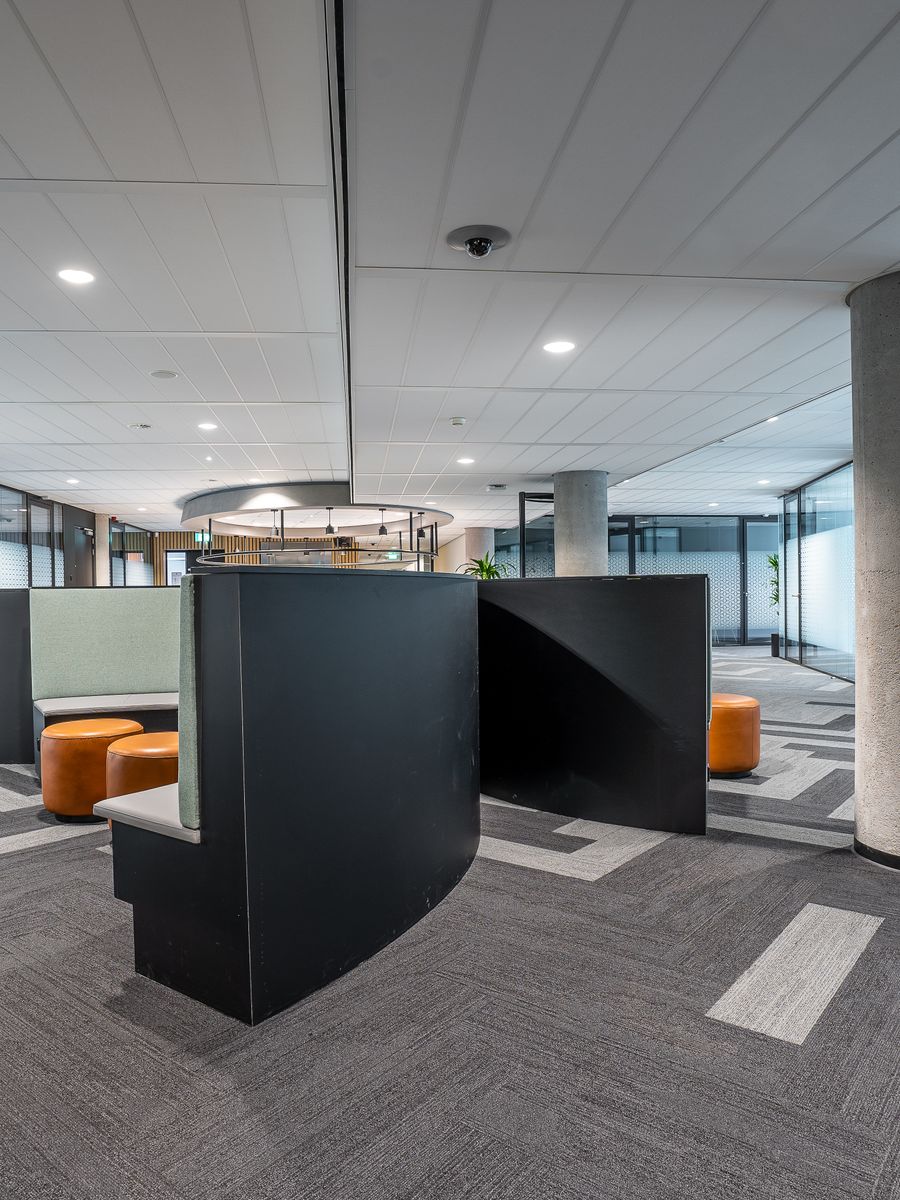 Open-plan workstations with glass meeting rooms