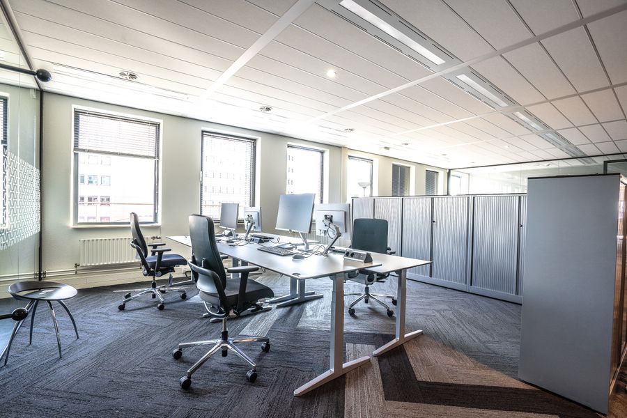 Open-plan commercial workspace with clean desks and flooring