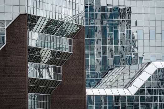 Abstract view of modern architecture featuring glass facades and geometric patterns.