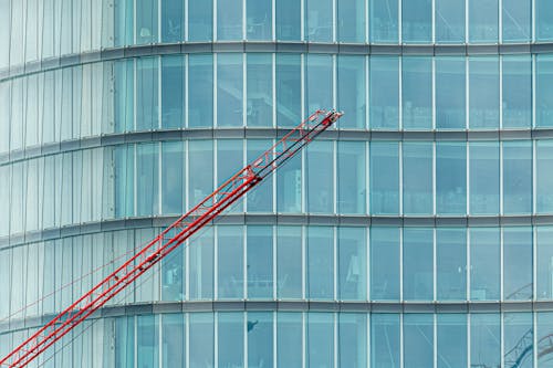 Free Red Building Crane Beside Glass Windows Stock Photo