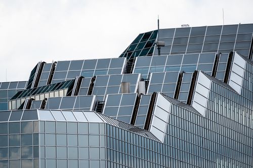 Free Close-up of a contemporary glass and steel skyscraper facade in an urban setting. Stock Photo