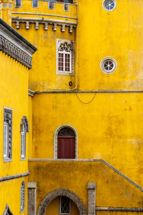 Free Close-up of the historic yellow facade of Pena Palace showcasing intricate architectural details. Stock Photo