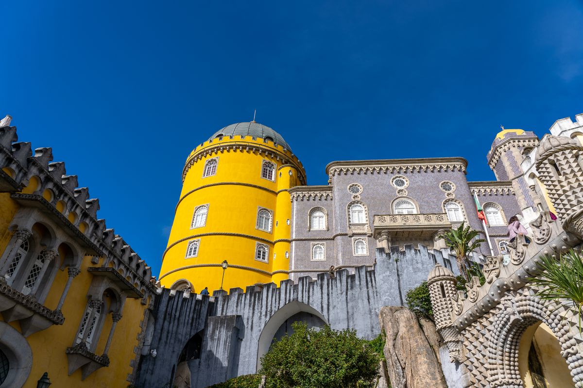 Sintra's Pena Palace — a 19th-century Romantic fantasy of towers and vivid color, 40 minutes from Lisbon.