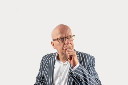 Free An Elderly Man with Eyeglasses Wearing a Striped Coat Stock Photo