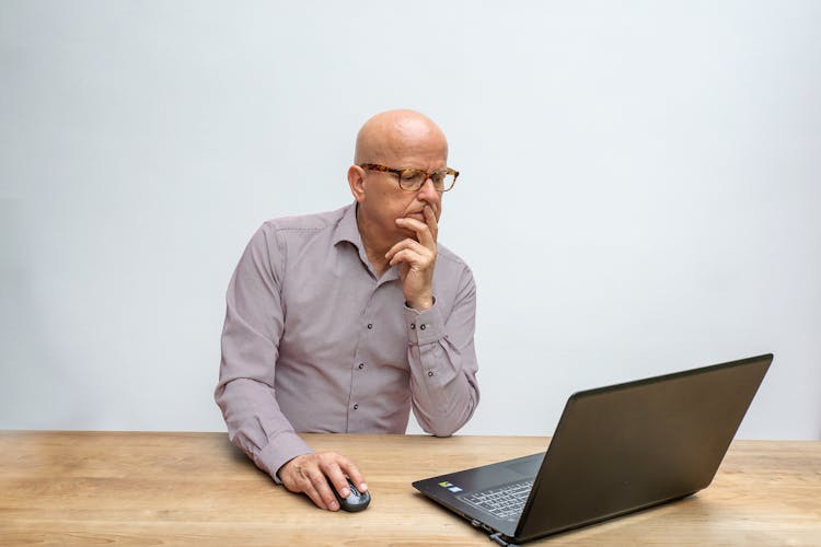 A Man Scrolling On His Laptop